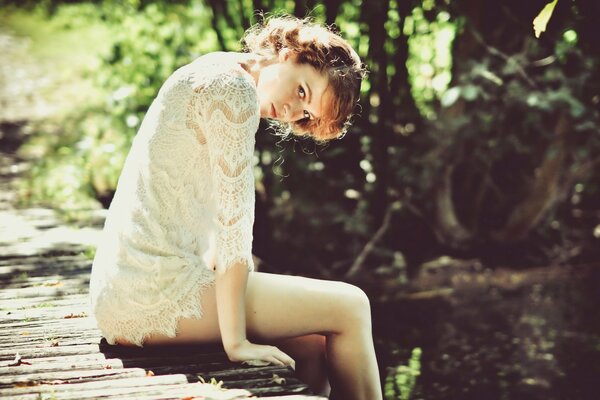 A beautiful girl is resting on the bridge