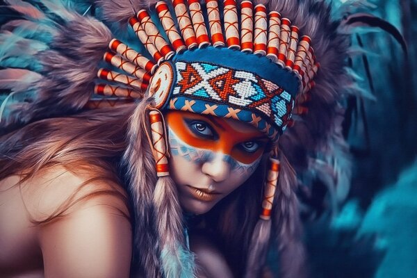 Indian girl with a painted face in a headdress