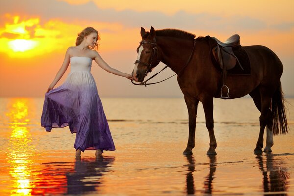 A girl with a horse on the seashore