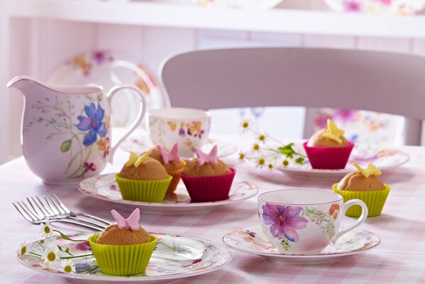 Delicious cupcakes on plates and tea are waiting for you for dessert