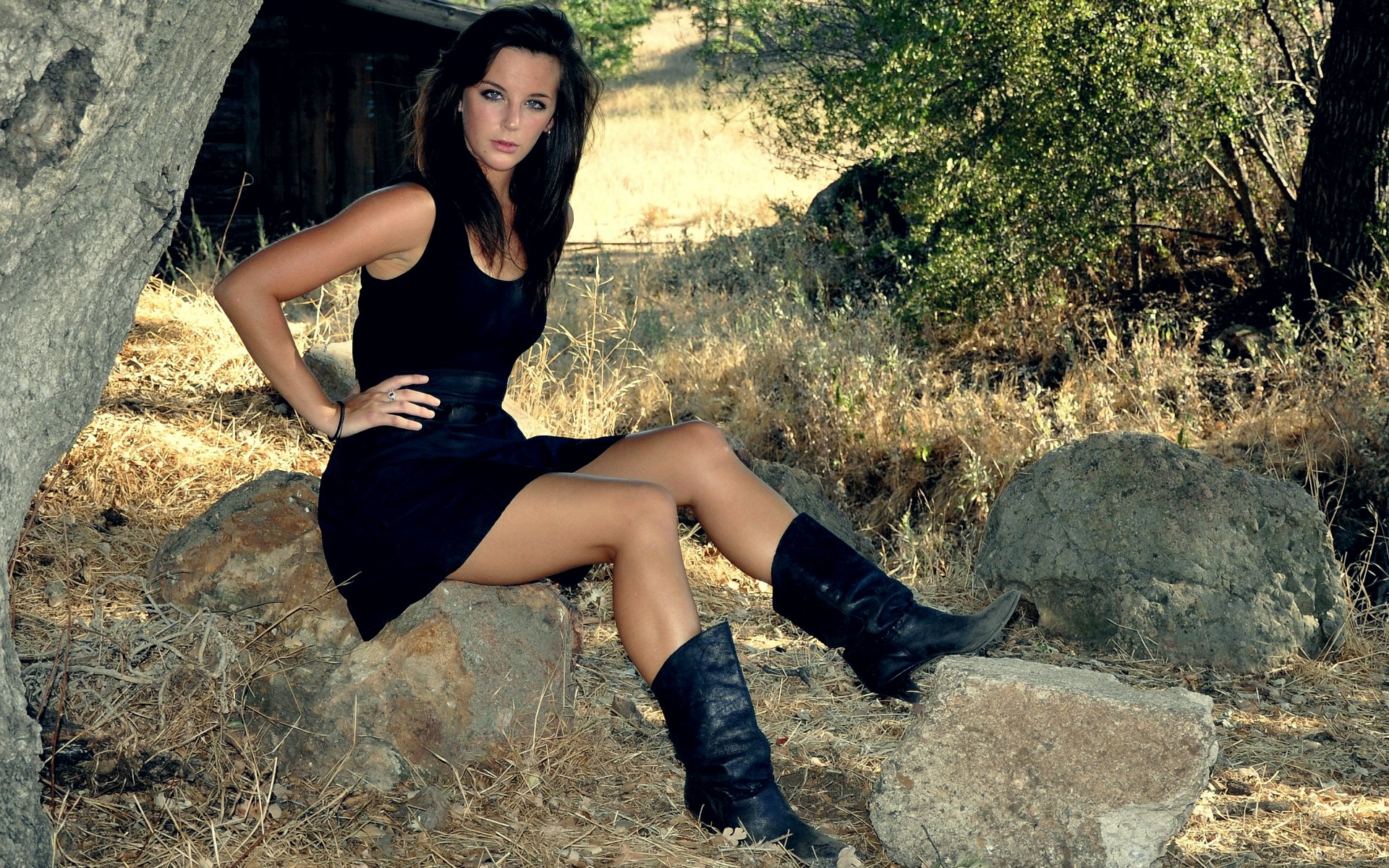 brunette hair eyes blue dress boots sitting background