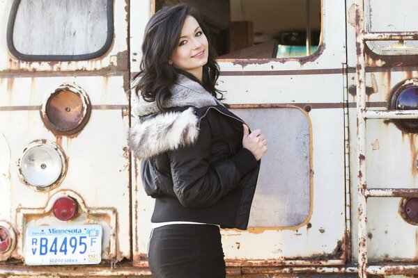 A very old bus and a girl