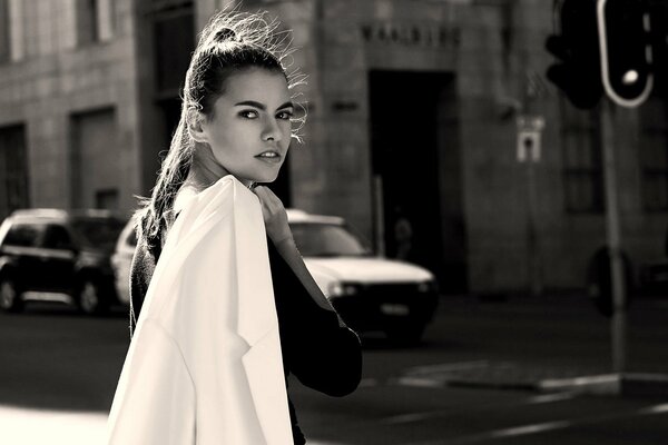 Beautiful girl on the street with a jacket