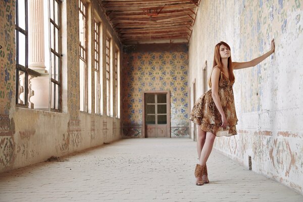 Red-haired girl in an old house