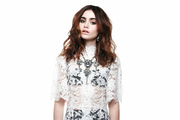 Lily Collins in a lace dress and black lingerie