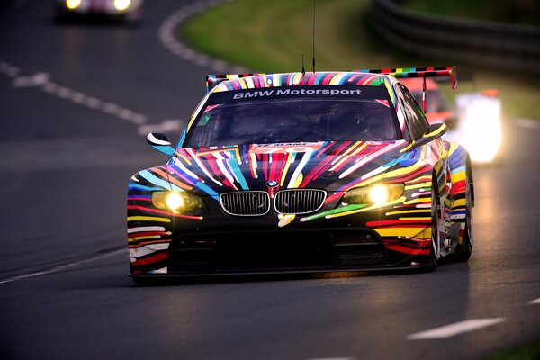 Sports BMW with multi-colored coloring, on the highway