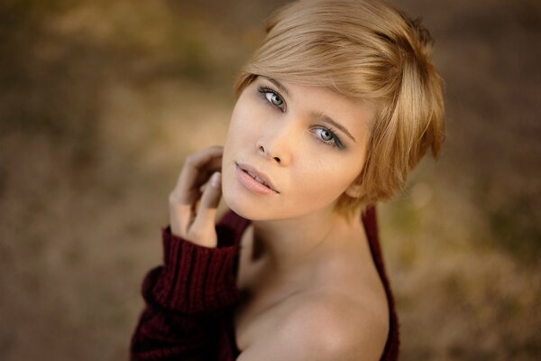 A woman with a short blonde haircut