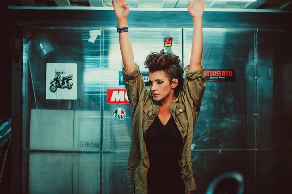 A brunette biker girl in the garage