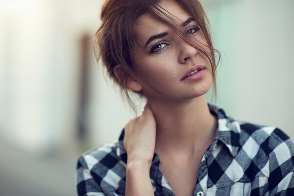 Stylish girl in a plaid shirt