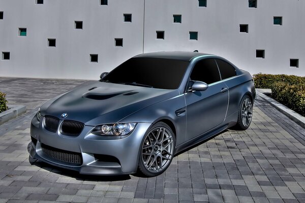 Silver tinted BMW on asphalt