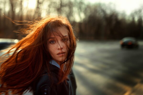 Portrait of a red-haired girl in autumn