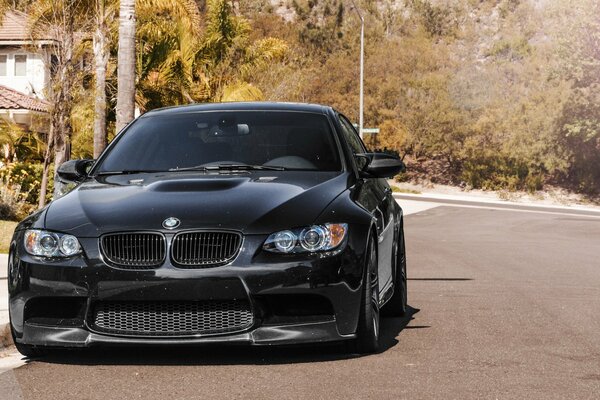 A black BMW car parked on the street