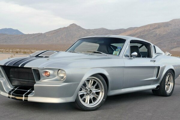 Silver ford mustang super snake sideways in the desert