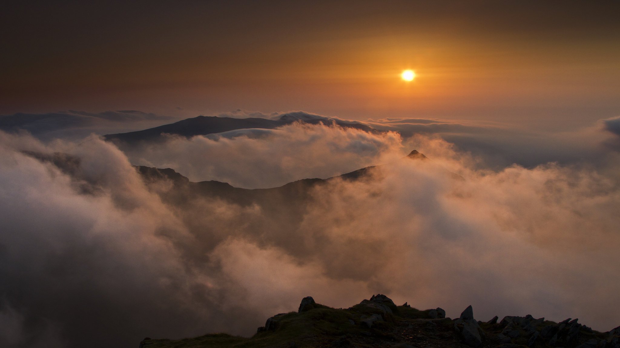 mountains fog the sun