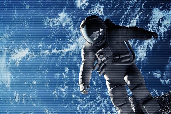 An astronaut in a spacesuit flies over the planet earth