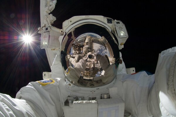 Self-portrait of an astronaut with a reflection of the earth