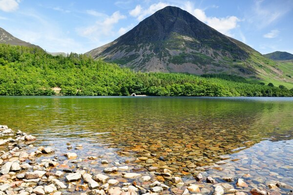 The rocky bottom of the lake. The mountain rises above the lake