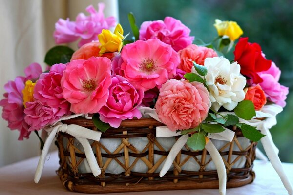 Multicolored flowers in a basket with white bows