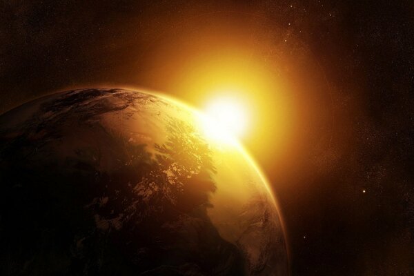 The sun illuminates the planet earth from space