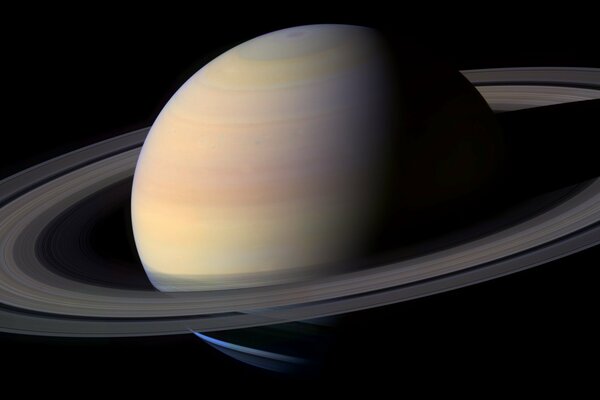 The planet Saturn with rings on a dark background