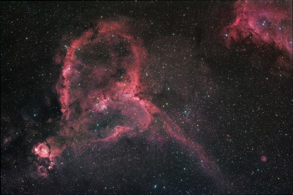 Red nebulae against a sky studded with stars