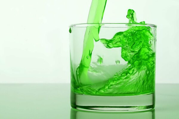 Green energy drink effectively poured into a glass