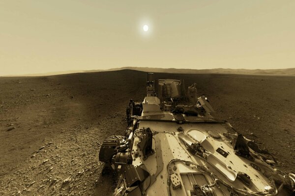 A rover on Mars against the background of the sun