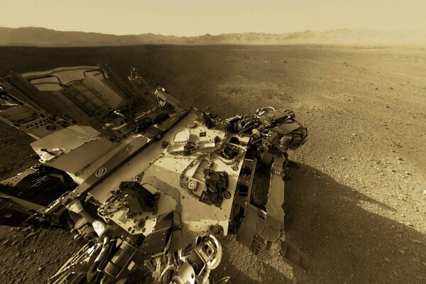 The rover on the background of the relief of Mars