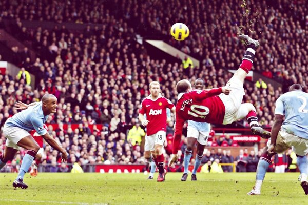 A football player in a jump hits the ball