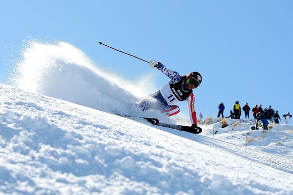 A skier descends the slope at the Olympic Games