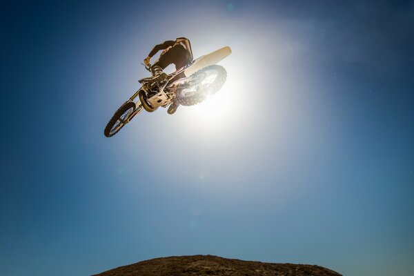 Motorcyclist on a white motorcycle racing