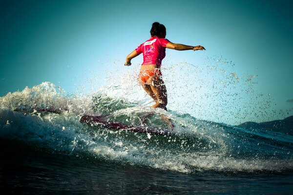 Girl surfing in the ocean