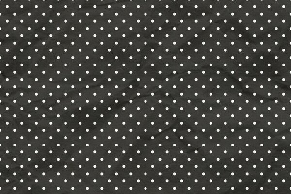 Black background with white polka dots