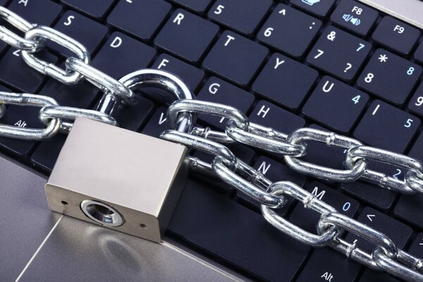 A locked laptop. Lock with a chain on the keyboard