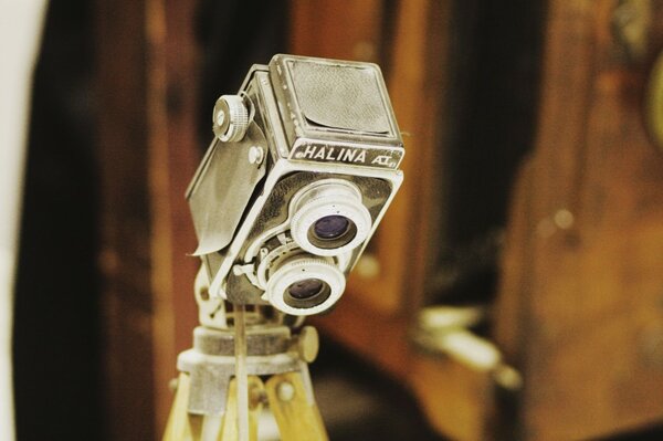 Vintage video camera lens on a yellow tripod