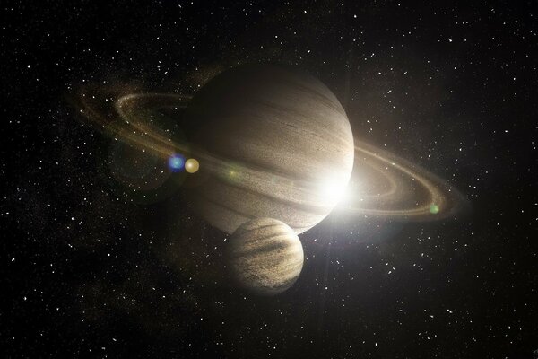 Saturne avec son compagnon sur fond d étoiles