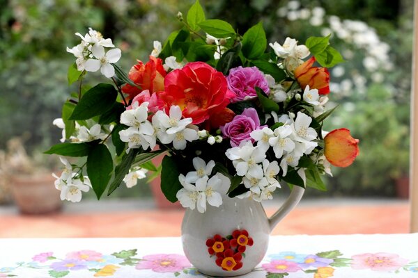 Jar with jasmine, branches and roses