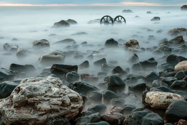 Seashore with rocks in the fog