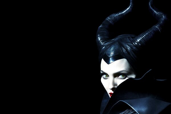 Angelina Jolie as Maleficent on a black background