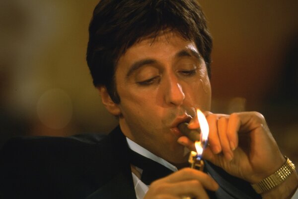 Al Pacino lights a cigar