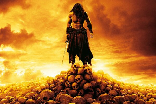 A warrior stands on a mountain of skulls