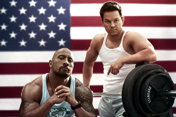 Two pumped-up men on the background of the flag