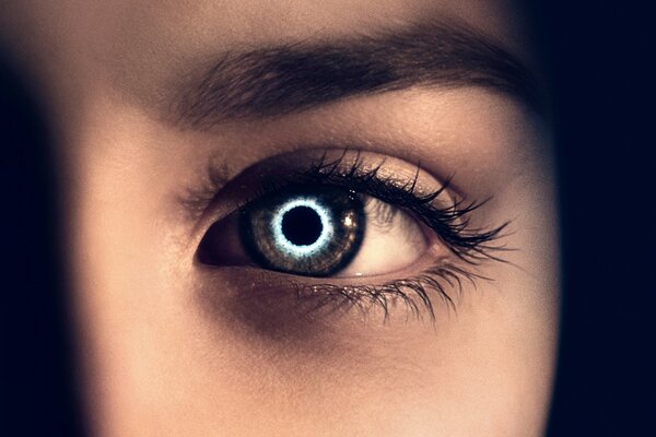 A girl s eye with a black hole reflection