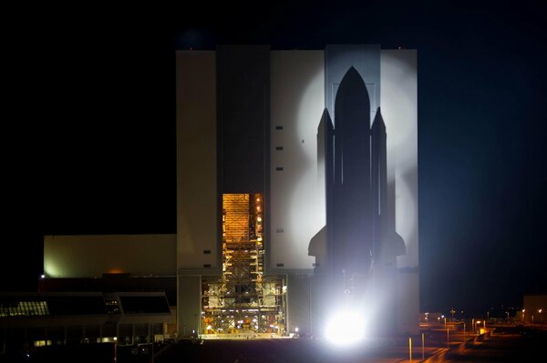 Silhouette eines Space Shuttle mit Nachtstadthintergrund