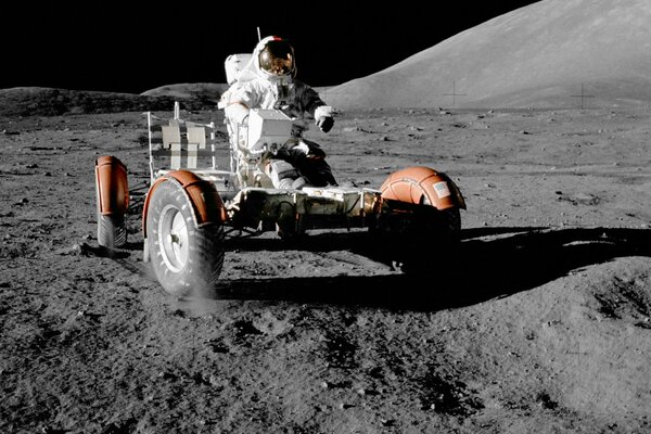 A man rides on a transport on the moon