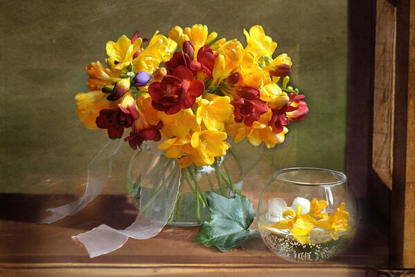 Summer bouquet of freesias in a glass vase