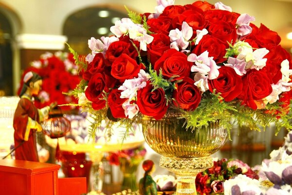 Bouquet of red roses in a golden vase