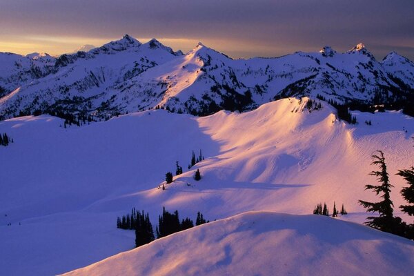 Winter mountains in the snow at sunset