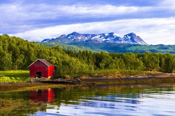 Red house on the riverbank in Norway