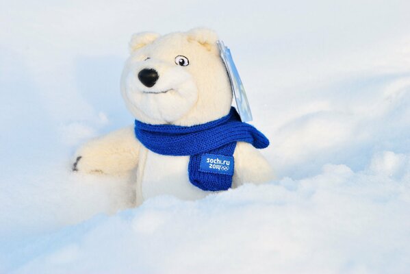 Olympic bear in a blue scarf in the snow